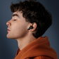 User wearing CTRL8 CMT Ultra Pro true wireless noise-cancelling earbuds for immersive audio experience