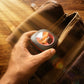 A user placing CTRL8 K7 true wireless earbuds with AI ENC-P in a sleek charging case into a leather bag, ideal for travel or daily use.