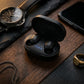 CTRL8 A6S wireless earbuds in sleek black charging case placed on a wooden surface alongside accessories.