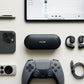 CTRL8 X29 open-ear headphones with charging case placed alongside gaming and tech accessories for immersive audio experience
