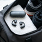 CTRL8 X29 open-ear headphones with charging case placed in a gym bag for fitness enthusiasts